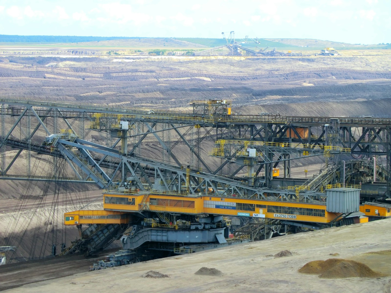 Open-pit coal mining with bucket-wheel excavator and conveyor infrastructure